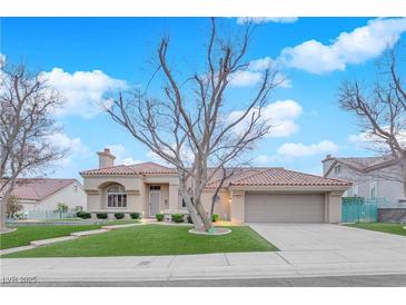 Charming single-story home featuring a red tile roof, manicured lawn, and an attached two-car garage at 9609 Eagle Valley Dr, Las Vegas, NV 89134