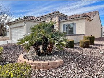 Charming single-story home with desert landscaping, stone accents, and a two-car garage at 2608 Dearport Ct, Henderson, NV 89052