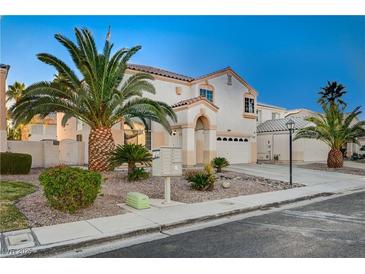 Two-story house with palm trees and a driveway at 2721 Tahiti Isle Ave, North Las Vegas, NV 89031