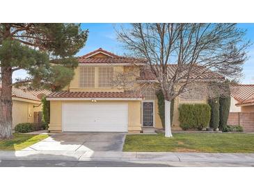 Attractive two-story house with a well-maintained lawn and a two-car garage at 2823 Camelback Ln, Henderson, NV 89074