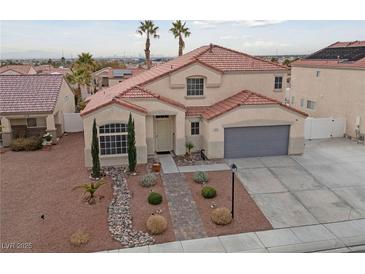 Two-story house with landscaped yard and attached garage at 319 Horse Pointe Ave, North Las Vegas, NV 89084