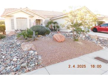 Charming single-story home with well-maintained desert landscaping and mature trees in a serene neighborhood at 3951 Candleglow Ct, Las Vegas, NV 89147