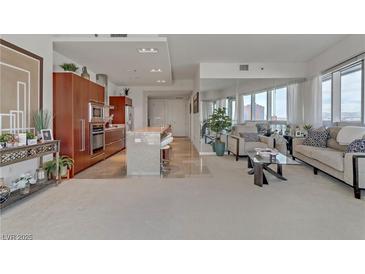 Open-concept living area featuring a modern kitchen, comfortable seating, and city views at 4471 Dean Martin Dr # 2000, Las Vegas, NV 89103