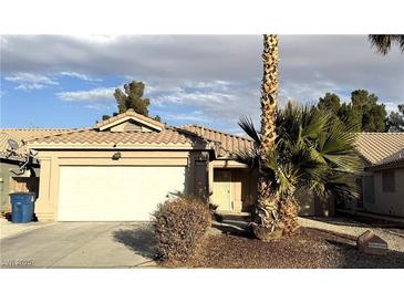 Single-story house with a white garage door and desert landscaping at 4604 Possum Berry Ln, North Las Vegas, NV 89081