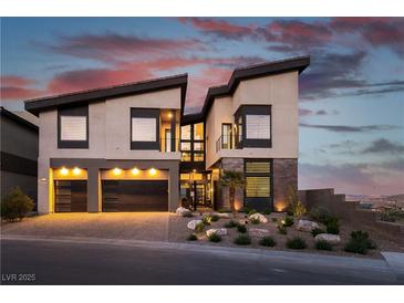 Modern two-story home with a three-car garage, desert landscaping, and a striking contemporary design at 5436 Succulent Rose Dr, Las Vegas, NV 89135