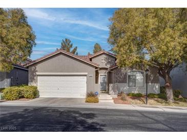 Single-story home with attached garage and landscaped front yard at 5600 Nimes Ave, Las Vegas, NV 89141