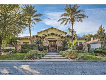 Stunning two-story house with a gated entrance and manicured lawn at 5895 S Gateway Rd, Las Vegas, NV 89120