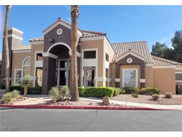 Building exterior with Spanish-style architecture and landscaping at 8101 W Flamingo Rd # 2040, Las Vegas, NV 89147