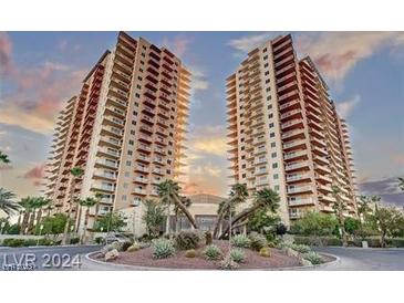 Stunning exterior of a high-rise condominium building with lush landscaping and a grand entrance at 8255 Las Vegas Blvd # 611, Las Vegas, NV 89123