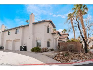 Two-story house with attached garage and landscaped yard at 932 Angel Star Ln, Las Vegas, NV 89145