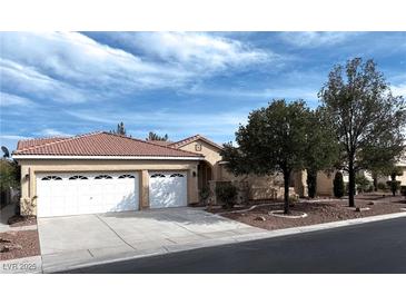 Charming single-story home featuring a terracotta roof, three-car garage and well-maintained landscaping at 8682 Waterford Bend St, Las Vegas, NV 89123