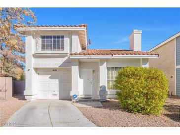 Cute two-story house with a one-car garage and landscaped front yard at 122 Boysenberry Ln, Henderson, NV 89074