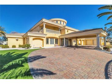 Stunning home features a circular driveway, porte cochere, lush landscaping, and grand architectural design at 1245 S Rancho Dr, Las Vegas, NV 89102