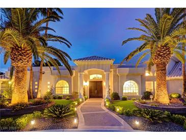 Elegant home with palm trees, landscaped yard, and a grand entrance at 2200 Nordica Ct, Las Vegas, NV 89117