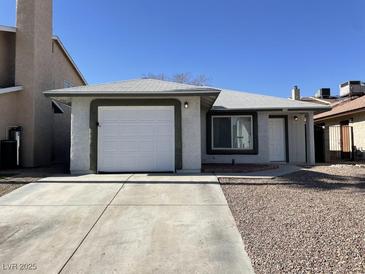 Charming single story house with a garage and low maintenance desert landscaping at 2420 Sweetgum St, Las Vegas, NV 89108