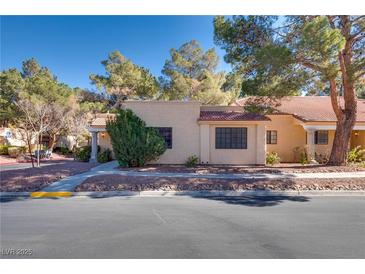 Tan stucco house with tile roof, walkway, and landscaping at 2851 S Valley View Blvd # 1172, Las Vegas, NV 89102