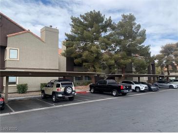 Exterior view of apartment building with covered parking at 5046 S Rainbow Blvd # 103, Las Vegas, NV 89118