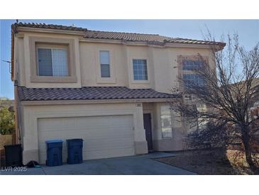 Two-story house with attached garage and landscaping at 5325 Big Fawn Ct, Las Vegas, NV 89130