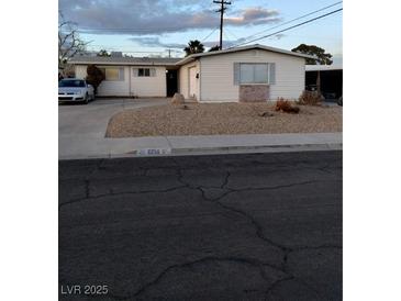 Ranch style home with a large yard and driveway at 6256 Dayton Ave, Las Vegas, NV 89107