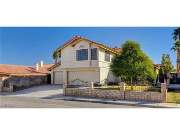 Two-story house with a two-car garage and a landscaped front yard at 7445 Shangri La Ave, Las Vegas, NV 89147