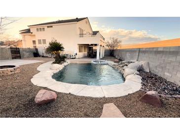 Relaxing backyard oasis with a sparkling pool and waterfall feature at 9290 Cool Creek Ave, Las Vegas, NV 89147