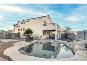 An inviting backyard pool and spa is surrounded by rock landscaping and patio space at 9290 Cool Creek Ave, Las Vegas, NV 89147