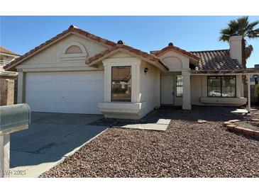 One-story house with a two-car garage and a landscaped front yard at 1275 White Dr, Las Vegas, NV 89119