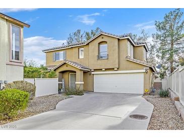 Two-story house with attached garage and landscaped front yard at 1903 Sundown Canyon Dr, Henderson, NV 89014