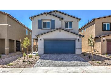 Two-story home with gray siding, blue garage door, and landscaping at 2633 Snapdragon Falls Ave # 104, North Las Vegas, NV 89081