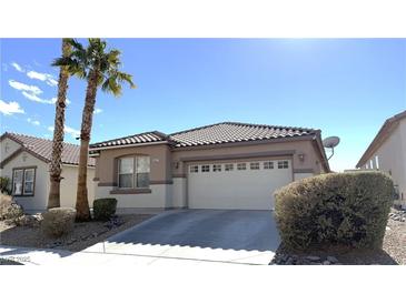 Charming single-story home featuring a two-car garage, low maintenance landscaping, and a tile roof at 3317 Barada Heights Ave, North Las Vegas, NV 89081