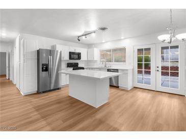 Modern kitchen with island, stainless steel appliances, and white cabinets at 4083 Eileen St, Las Vegas, NV 89115