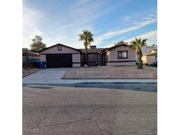 Single story home with a two car garage and xeriscaped yard at 6741 Solaron Ave, Las Vegas, NV 89156