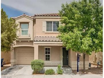 Two-story house with tan siding, a dark-gray door, and a well-manicured lawn at 7732 Hand Woven Ct, Las Vegas, NV 89149