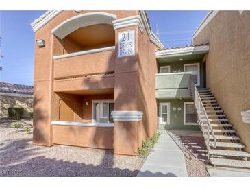 Two-story building with tan and orange exterior, balconies, and stairs at 8101 W Flamingo Rd # 1157, Las Vegas, NV 89147