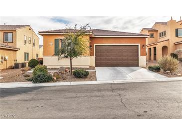 One-story house with brown garage door and landscaped yard at 825 Great Sky Ct, North Las Vegas, NV 89084