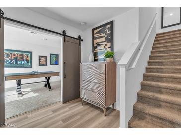 Inviting home entrance featuring a modern staircase and decorative accents that offers easy access to a game room at 2827 Blue Mosaic Ln # 3, Las Vegas, NV 89183