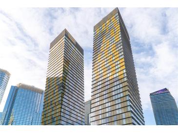 Striking exterior view of the Veer Towers showcasing modern architecture against a partly cloudy sky at 3722 Las Vegas Blvd # 305, Las Vegas, NV 89158