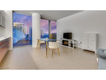 Modern living space featuring floor-to-ceiling windows with city views and minimalist decor at 3722 Las Vegas Blvd # 305, Las Vegas, NV 89158
