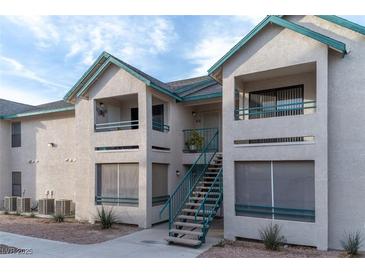 Two-story building exterior with teal accents and stairs at 5261 Lindell Rd # 205, Las Vegas, NV 89118
