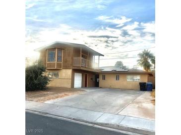 Two-story house with balcony, attached garage, and large yard at 3551 Rio Mayo Dr, Las Vegas, NV 89121