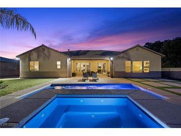 Relaxing backyard oasis featuring a refreshing pool, lounge chairs, and inviting patio furniture at 4292 Helena Cove Ct, Las Vegas, NV 89129