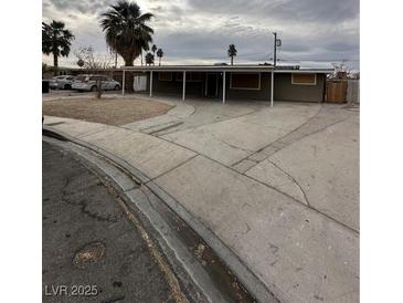 Ranch-style home with covered carport and mature palm trees at 717 N 21St St, Las Vegas, NV 89101