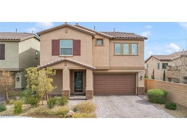 Two-story house with brown garage door and landscaped yard at 8136 Little Skye Ct, Las Vegas, NV 89166