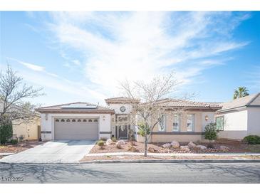 Charming single-story home with desert landscaping and a spacious three-car garage at 1901 Shady Elm St, Las Vegas, NV 89135