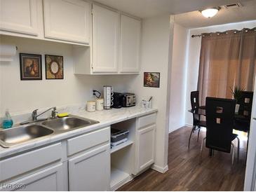 Bright eat-in kitchen with white cabinets and modern appliances at 200 N Bruce St # A, Las Vegas, NV 89101