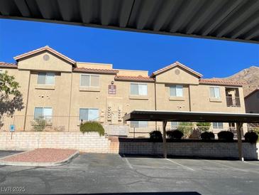 Tan two-story building with parking and mountain views at 2110 Los Feliz St # 1046, Las Vegas, NV 89156