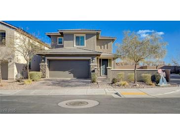 Charming two-story home with a neutral color palette, manicured landscaping, and an attached two-car garage at 422 Barcarolle Ln, Henderson, NV 89011