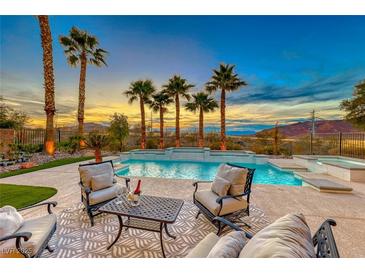 Luxury pool with patio furniture, offering stunning sunset views at 61 Contrada Fiore Dr, Henderson, NV 89011