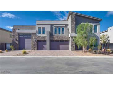 Contemporary home with stone accents and three-car garage at 8541 S Pioneer Way, Las Vegas, NV 89113