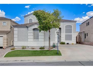 Attractive home exterior with manicured lawn, concrete driveway and mature landscaping at 190 Mount Saint Helens Dr, Henderson, NV 89012